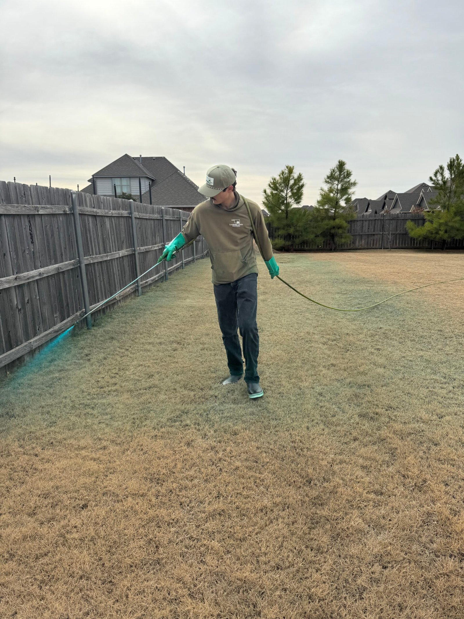 Superior Lawn Solutions technician treating a lawn
